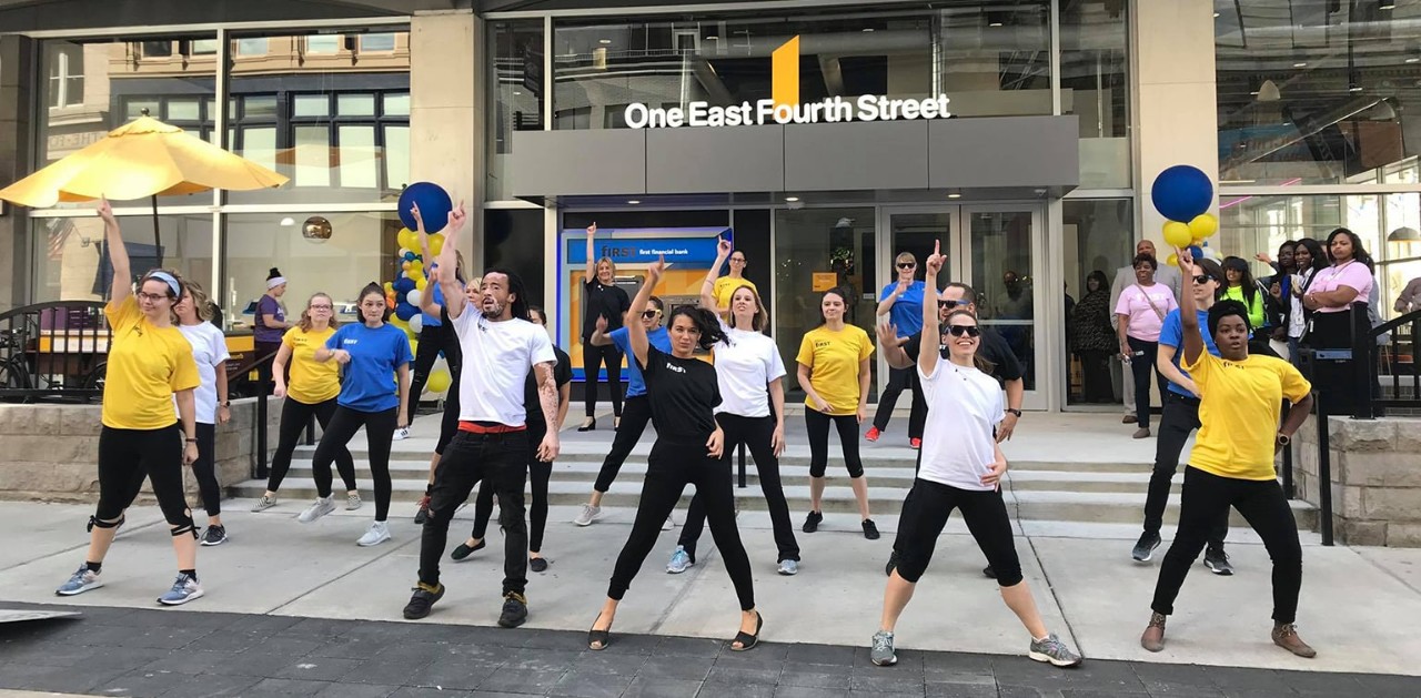 Diverse group of people dancing in a flash mob in front of 4th & Vine