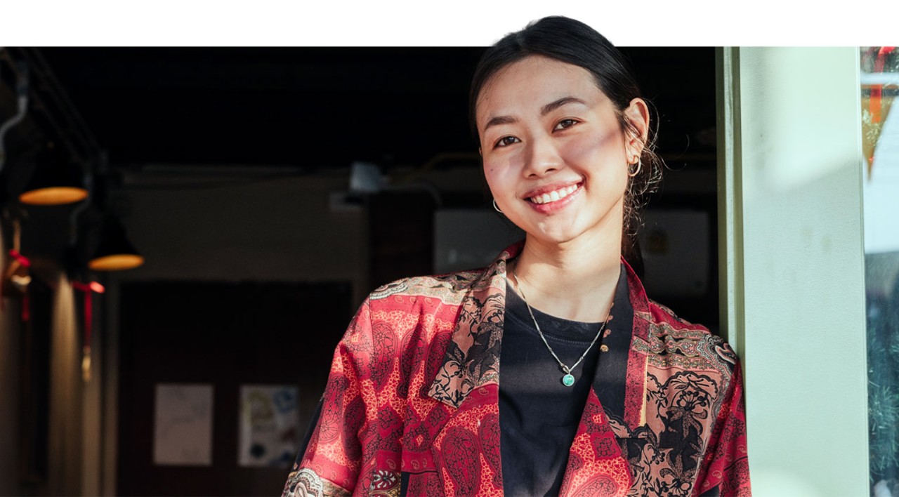 Young female business owner standing in front of her shop