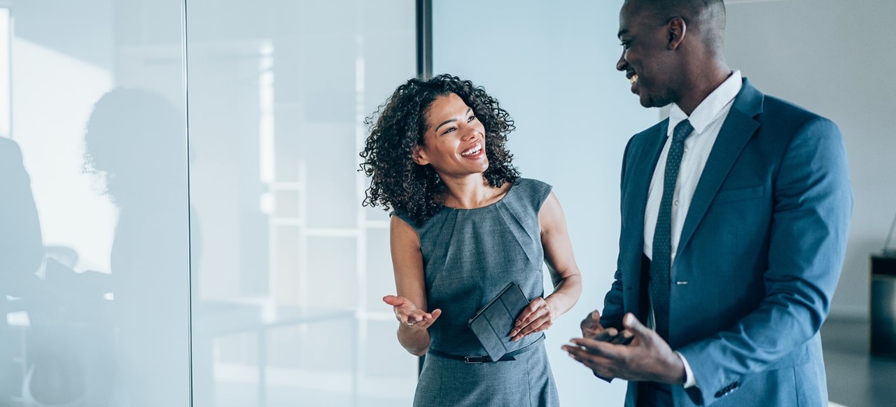 A businessman and businesswoman talk