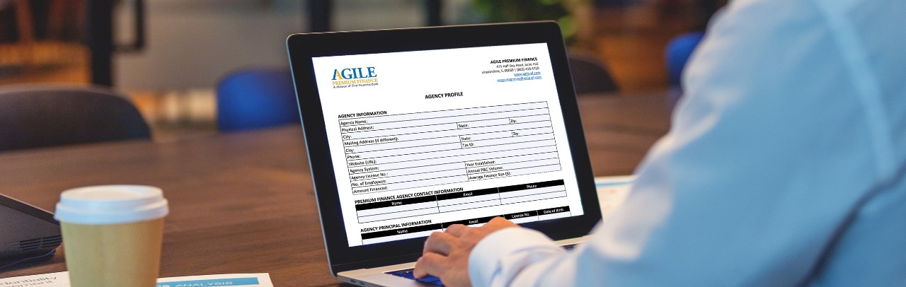 A man on a laptop looks at an Agile document