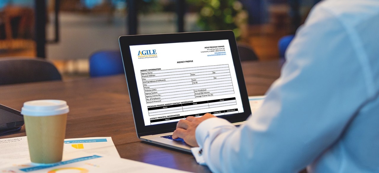 A man on a laptop looks at an Agile document