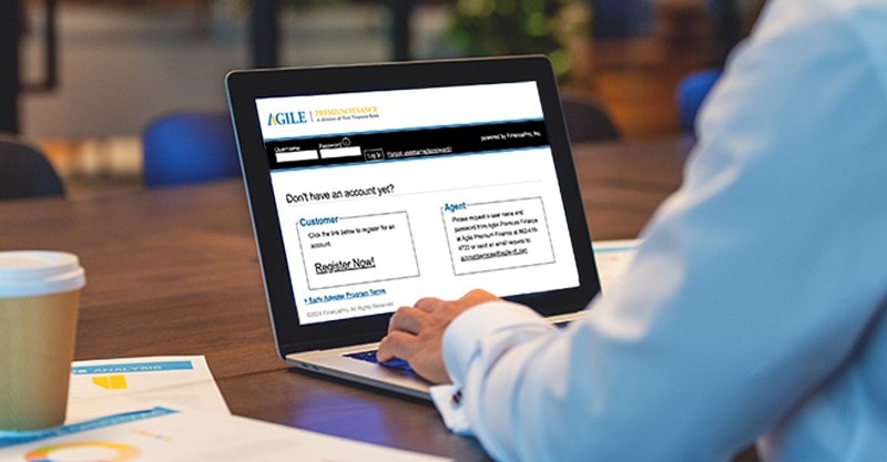 A man logs in to the Agile portal on his laptop