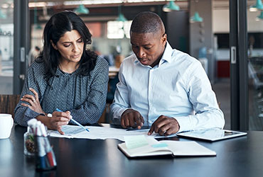 Business associates reviewing documents in conference room