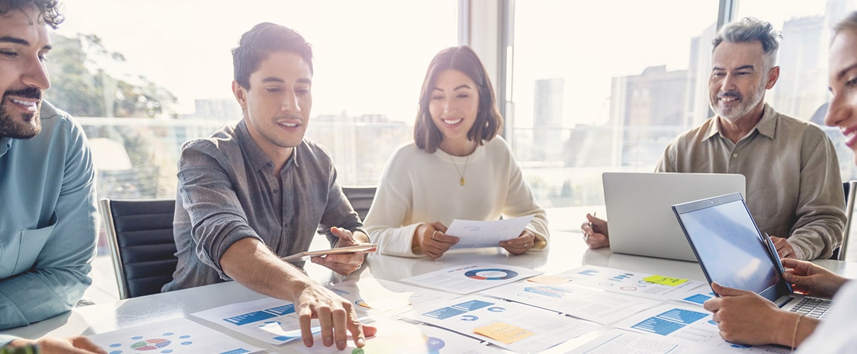Colleagues reviewing documents at conference table