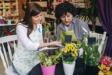 Floral shop owner training her successor