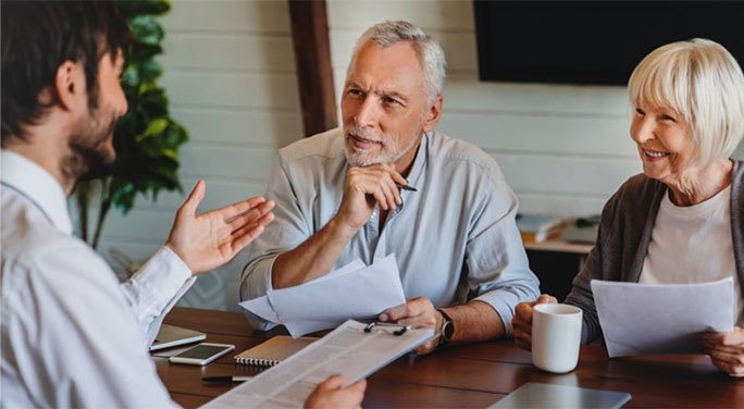 Senior couple reviewing documents with a financial advisor