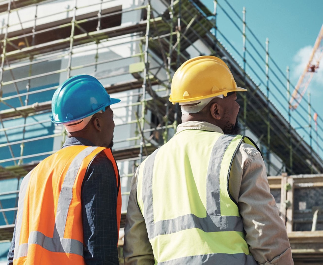 African-American workers assessing progress at a building construction site