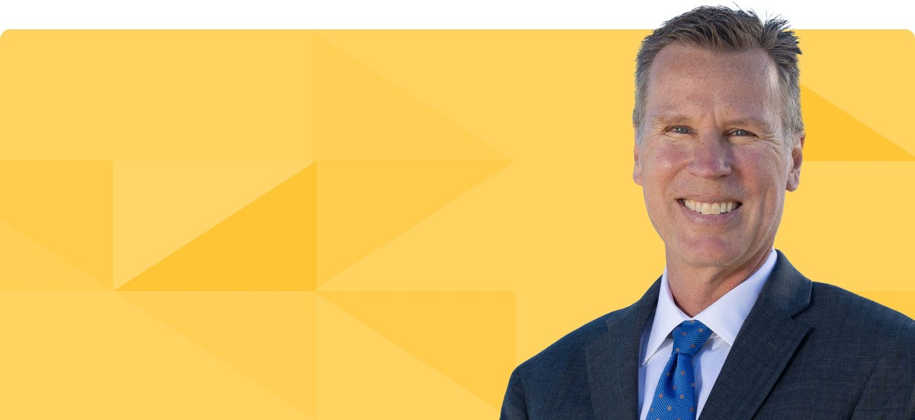 Headshot of David Dannemiller on a gold tessellated background