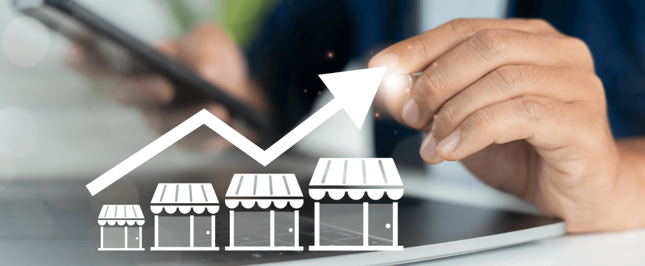 business owner points to a graphic showing business growth