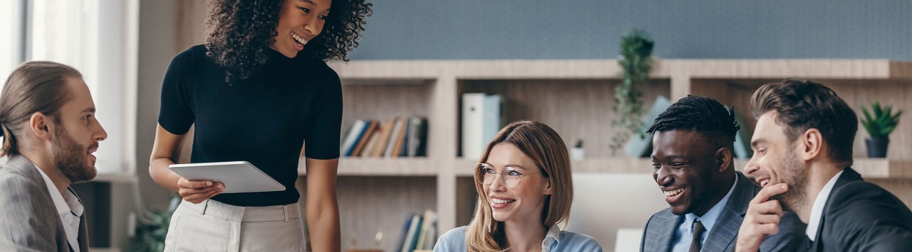 Smiling colleagues seated in conference room