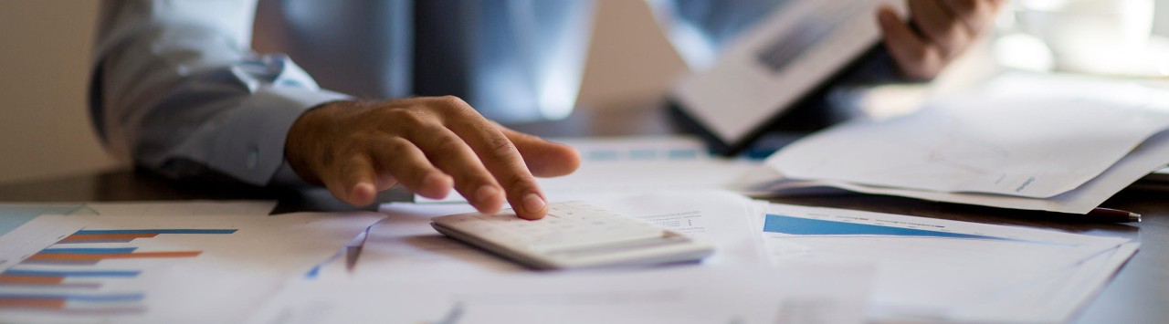 Image alt tag	A business owner sits at a desk with financial documents and a calculator