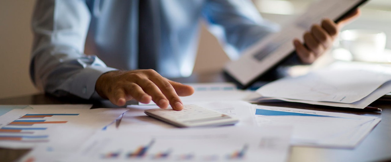 Image alt tag	A business owner sits at a desk with financial documents and a calculator