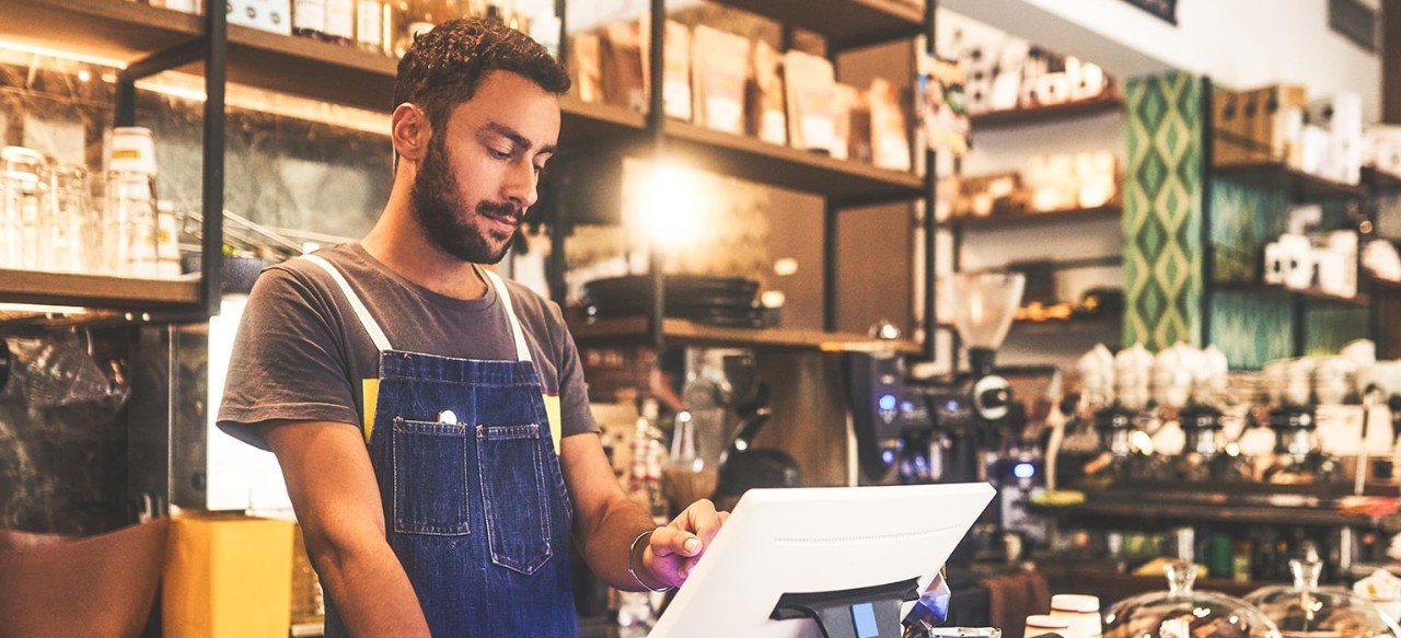 Man in a cafe at touch screen device