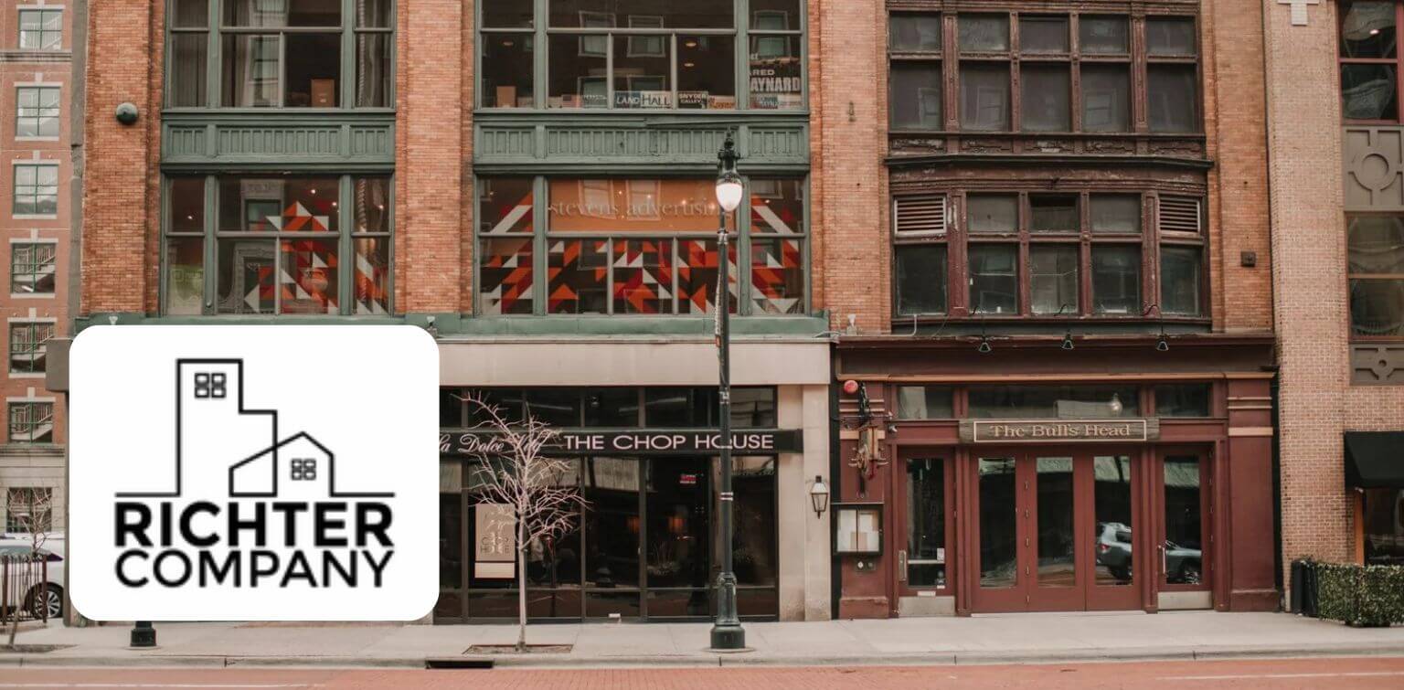 Richter Company logo overlaid on a downtown building with two storefronts