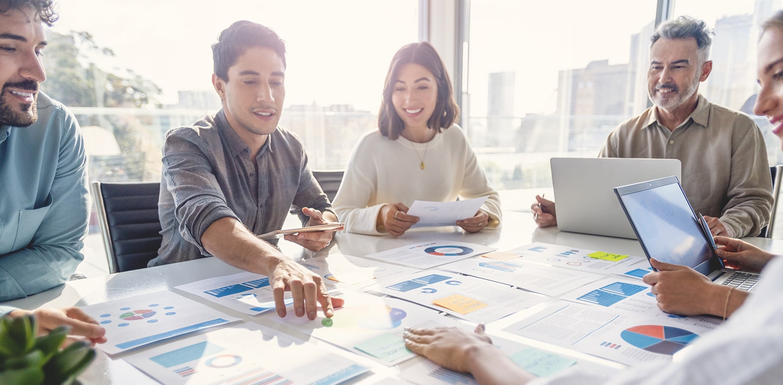 Group of colleagues reviewing financial data at conference table