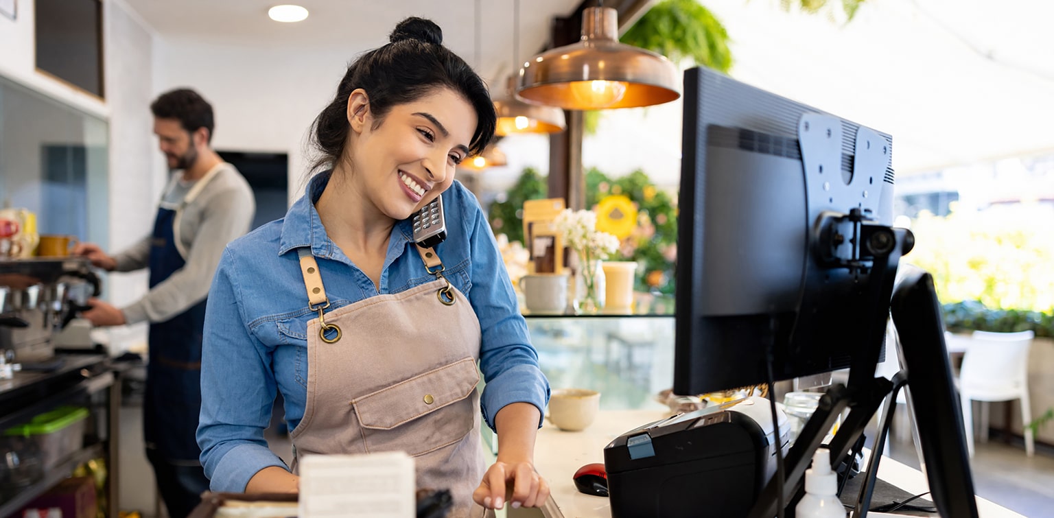 Female coffee shop owner taking order over the phone