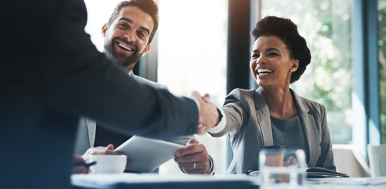 Business owners shaking hands with investor