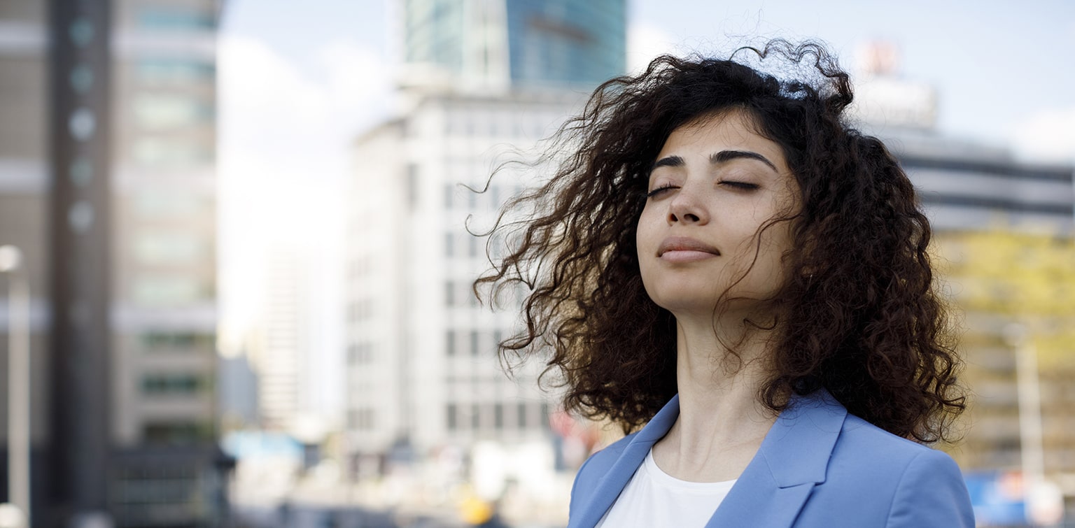 Businesswoman taking mental break outside in downtown setting