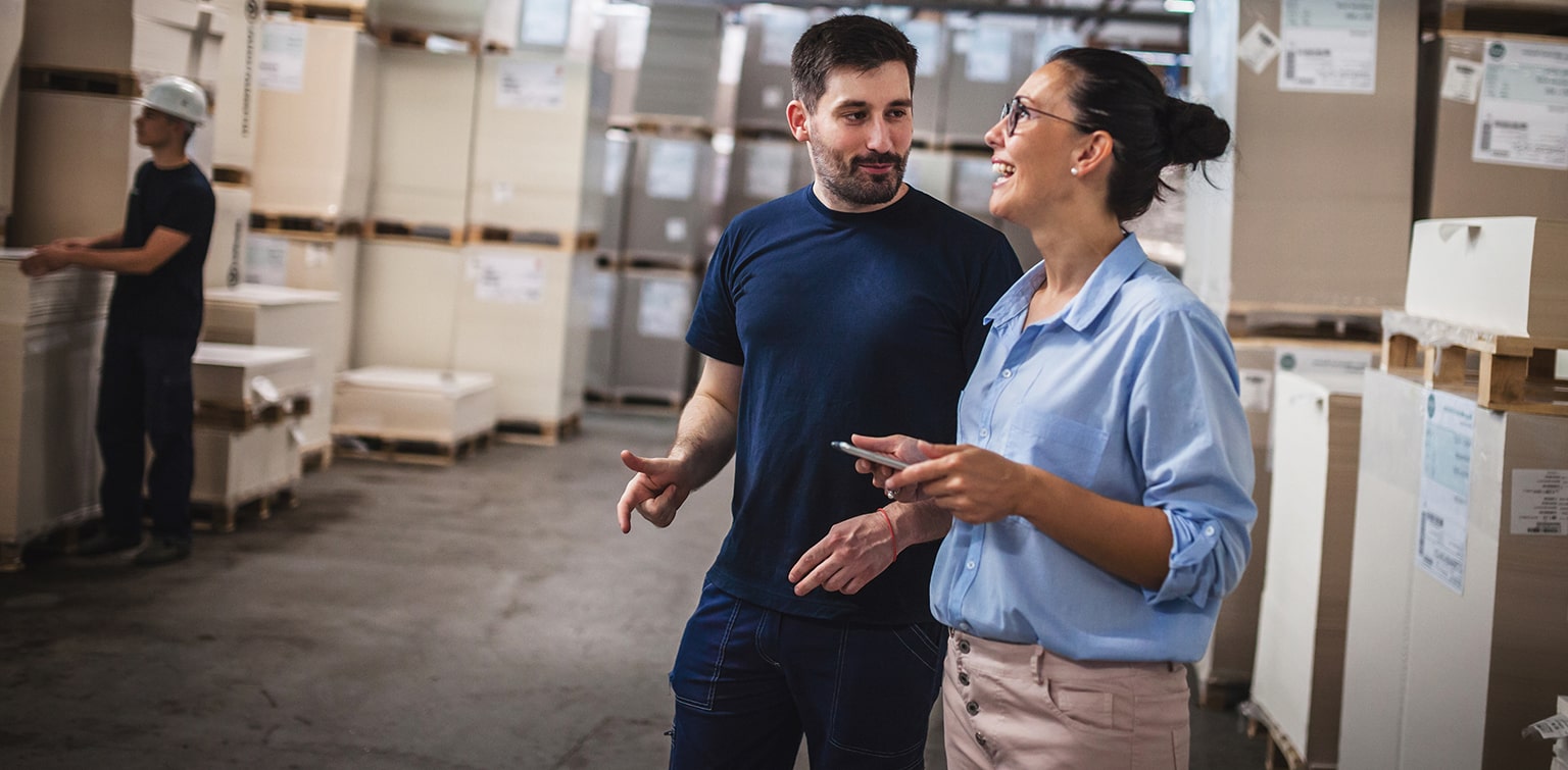 Female wholesale owner speaking to employee