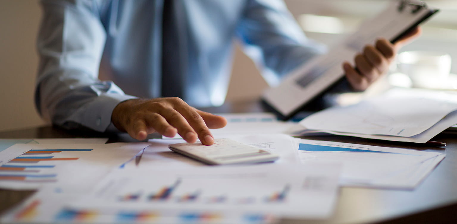 Image alt tag	A business owner sits at a desk with financial documents and a calculator