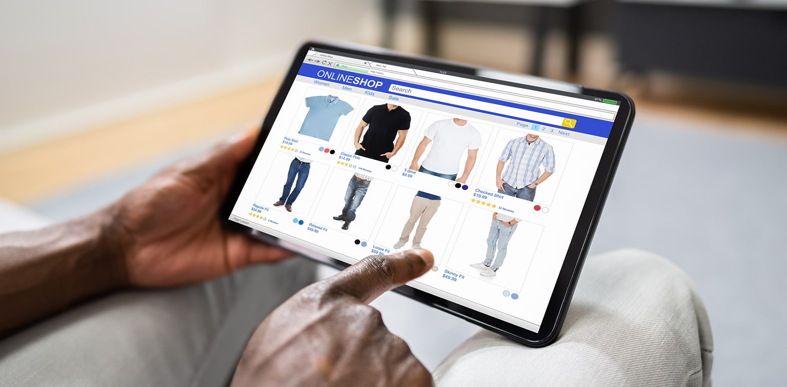 Man shopping for complementary clothing items on tablet