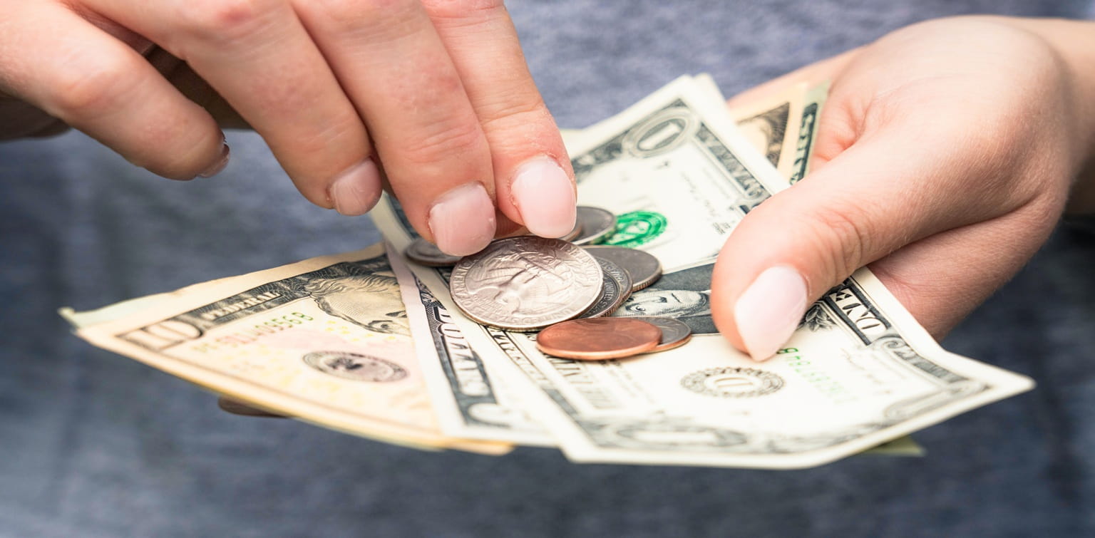 Hands holding American currency