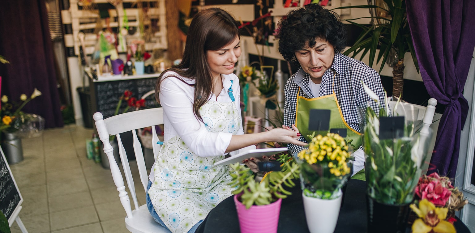 Floral shop owner training her successor