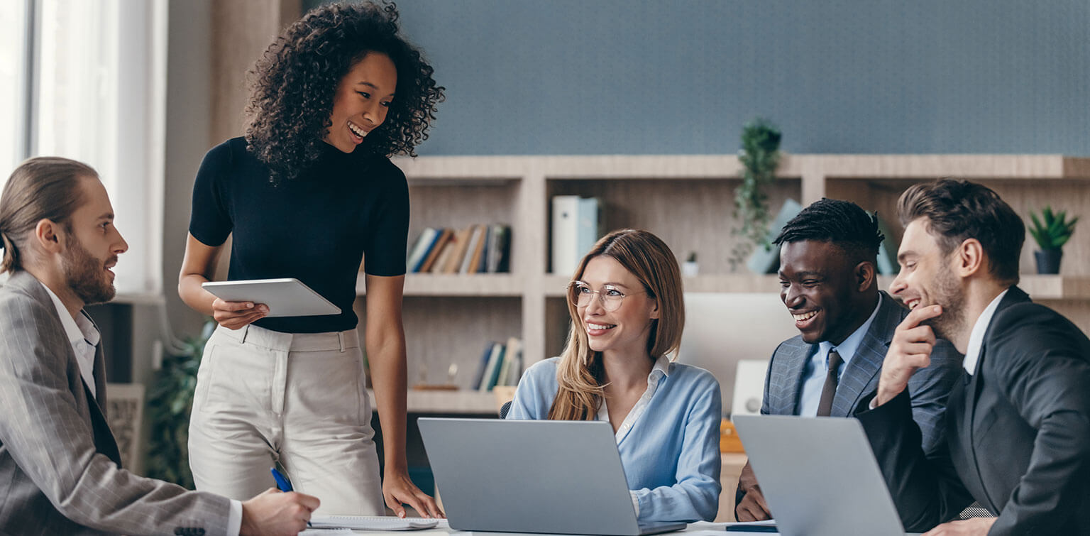Smiling colleagues seated in conference room