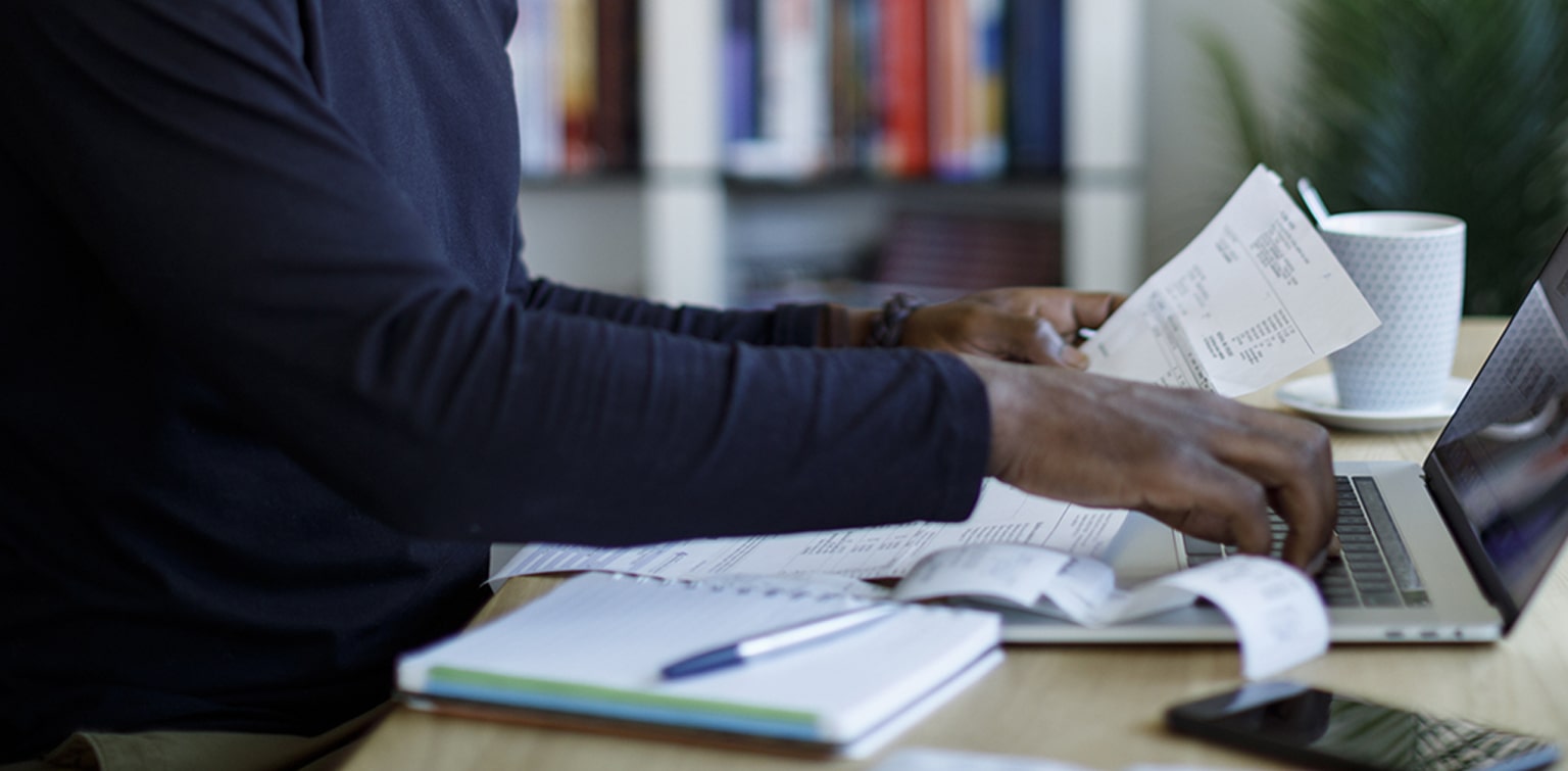 Business owner reviewing receipts while preparing taxes