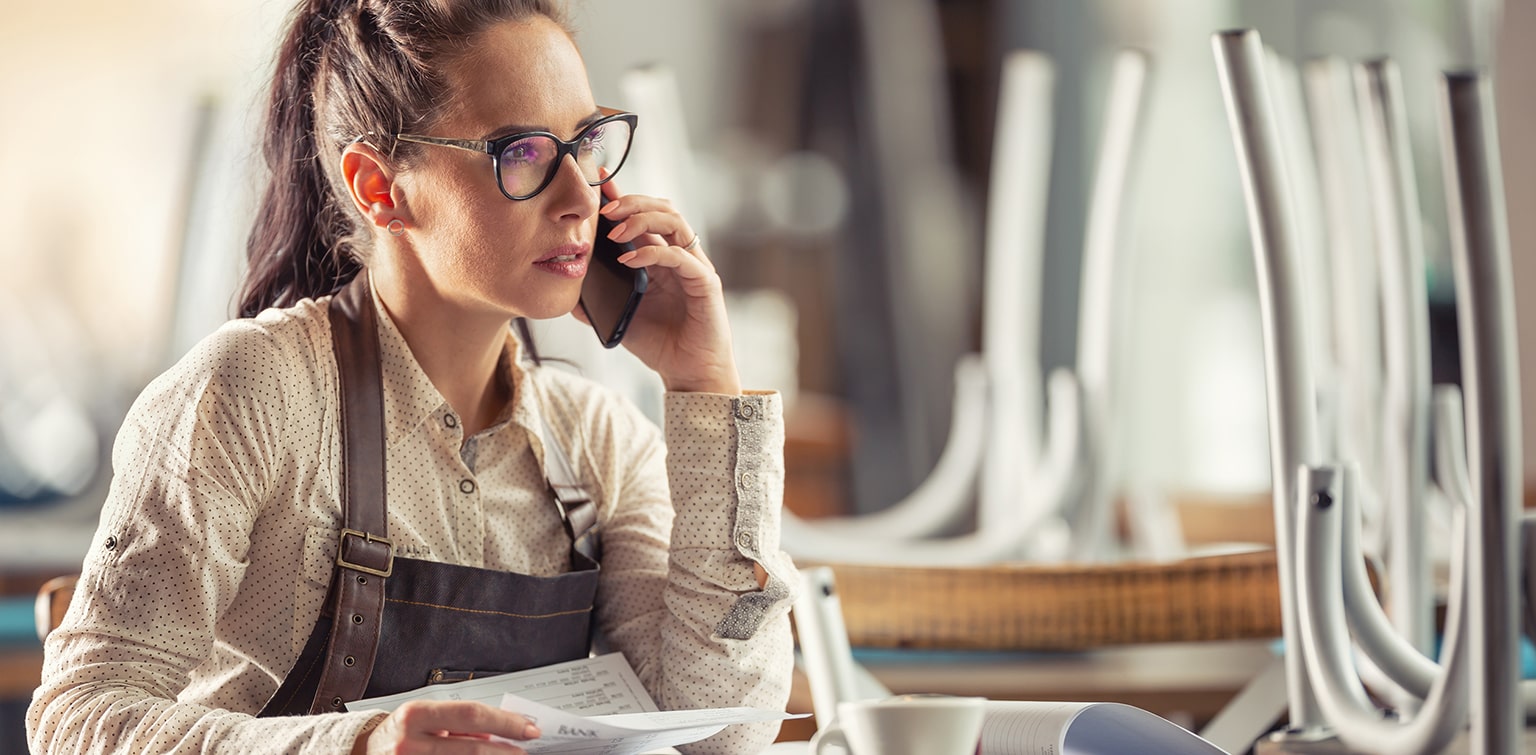 Worried restaurant owner talking on phone