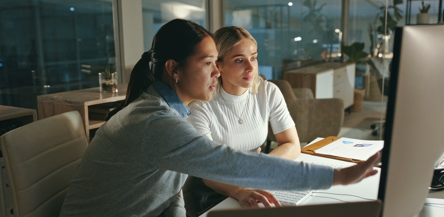 Two female business owners looking at computer monitor for security measures