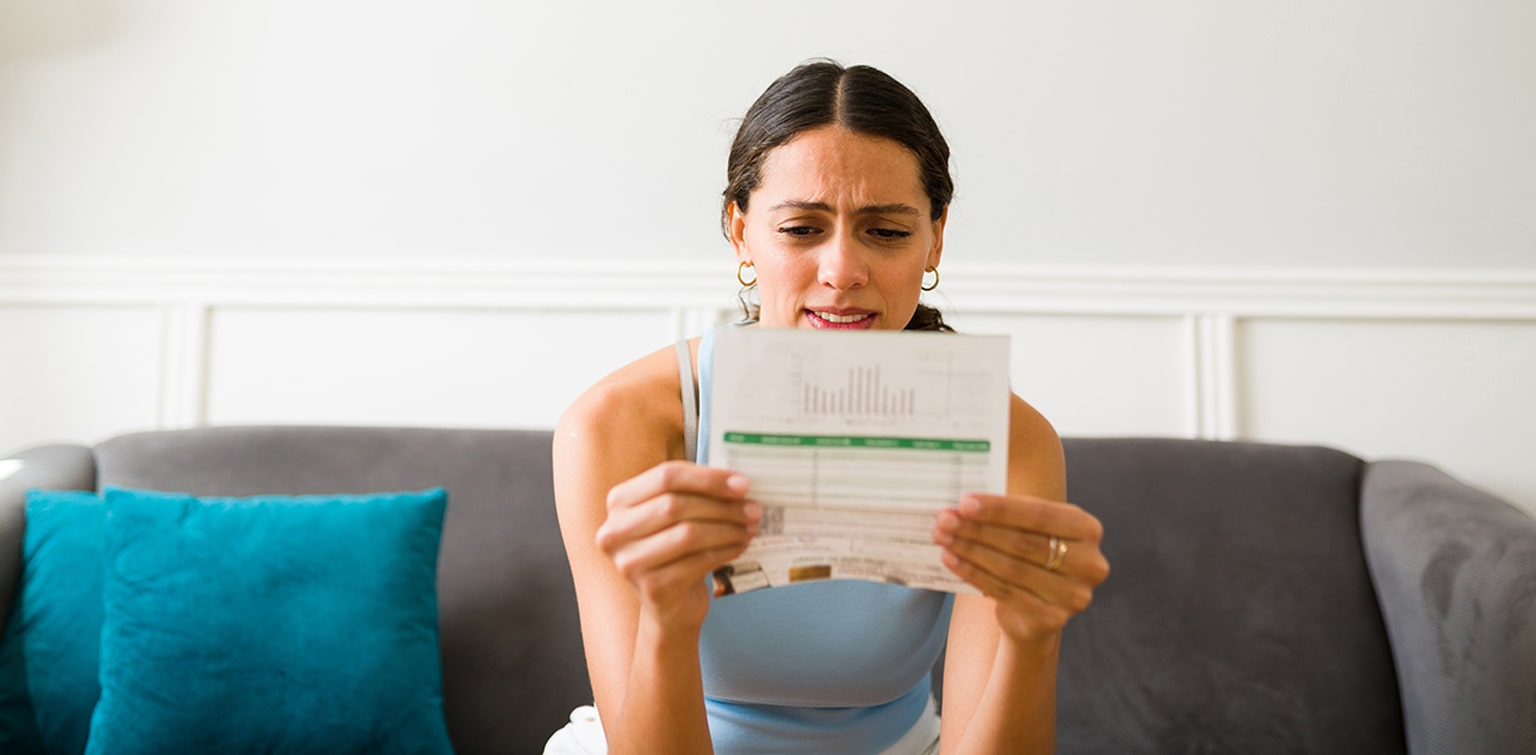 Concerned woman looking at credit card bill