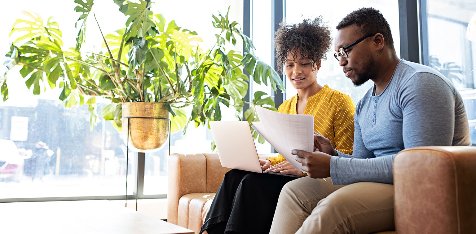 African-American couple reviewing budget at home