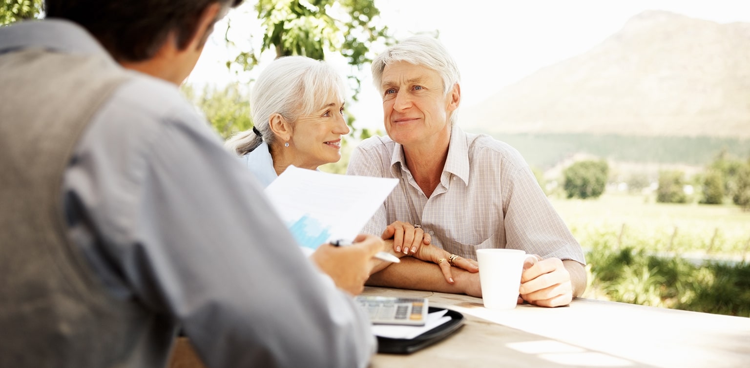 Mature couple reviewing trust plan with financial advisor