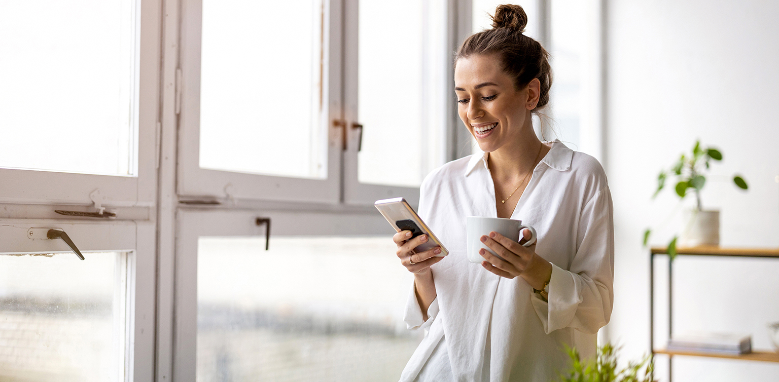 Shot of a young businesswoman using smartphone in an office