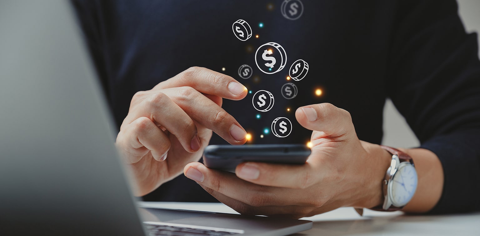 Man holding cell phone with graphic coins coming to life out of the screen.