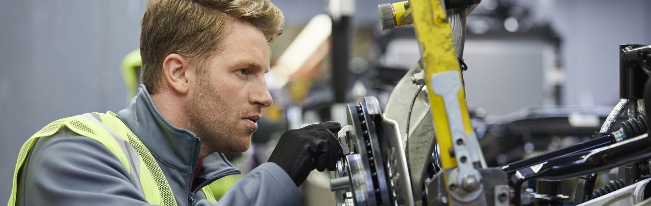 Factory employee working on gear equipment