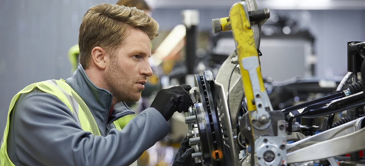 Factory employee working on gear equipment