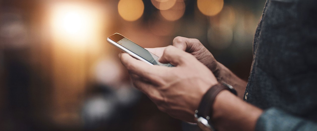 Close-up of man's hands holding a smartphone