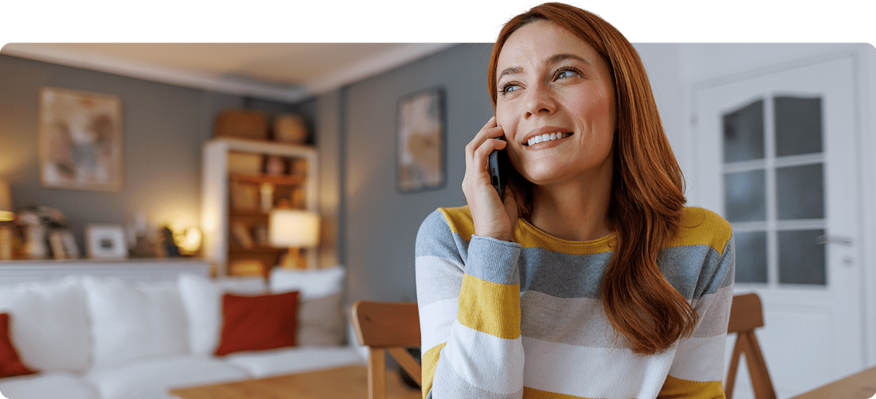 A woman engaged in a phone conversation in her cozy living room