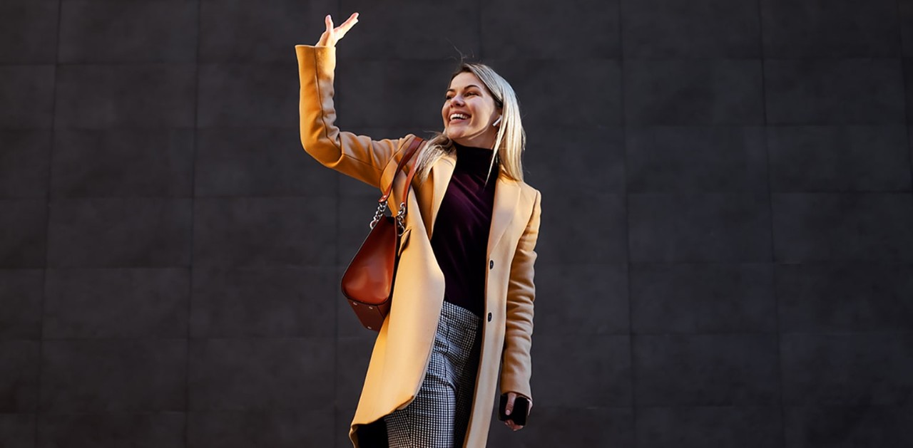 Woman walking away waving goodbye