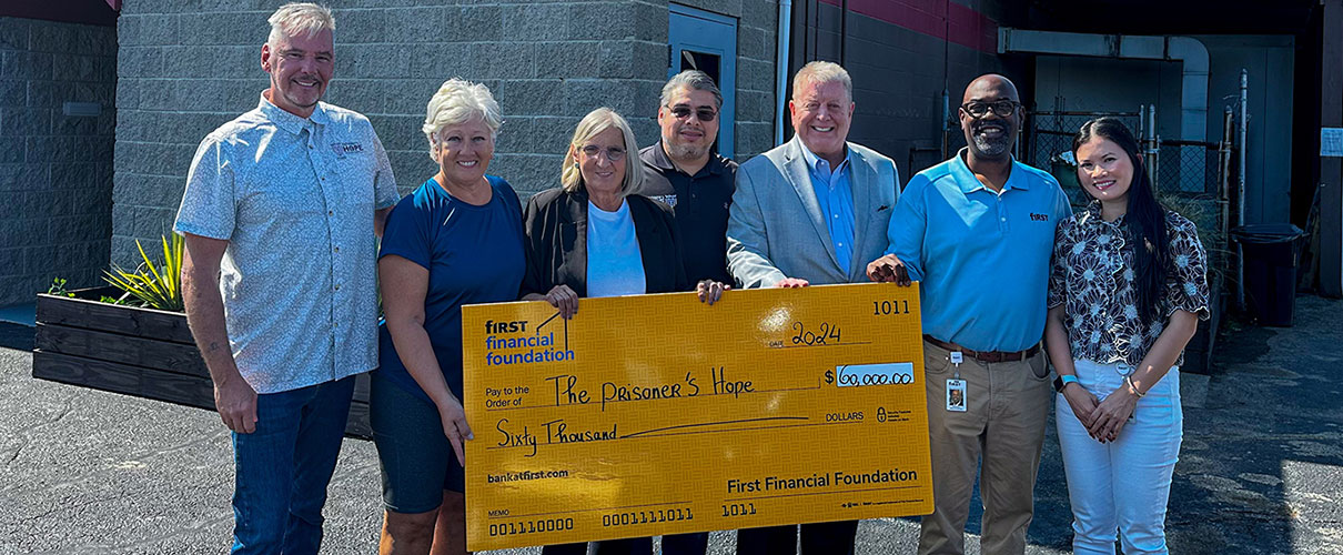 First Financial associates presenting donation check to The Prisoner's Hope