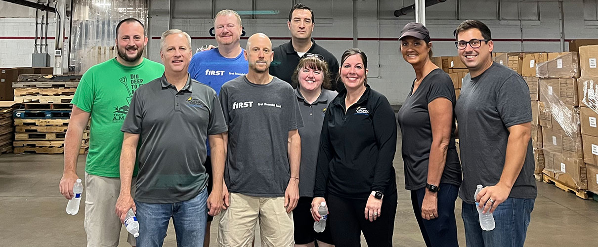 First Financial associates in a warehouse after volunteering