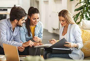 Couple reviewing documents with a financial advisor