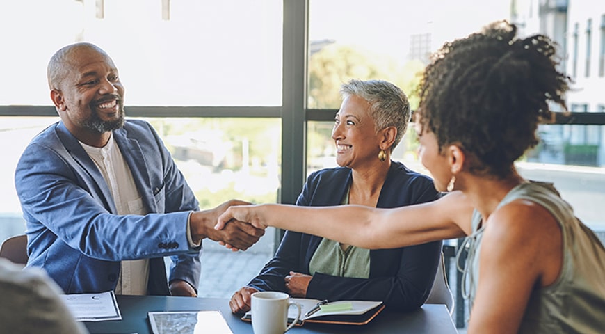 Middle-aged African-American couple meeting with private banker